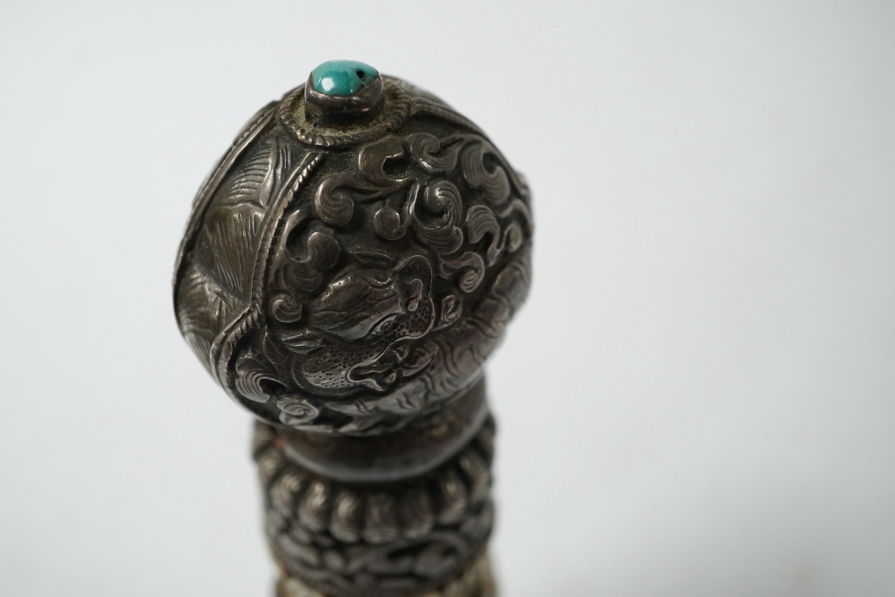 A Tibetan bone and repousse work seal, late 19th/early 20th century, 15cm high. Condition - fair